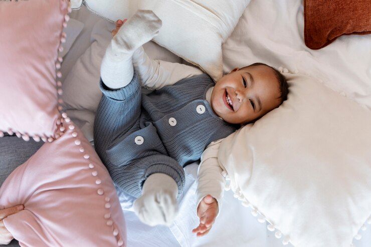 adorable-baby-laughing-laying-bed_23-2149355629.jpg